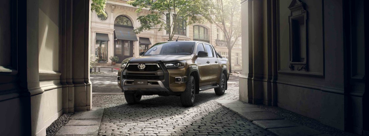 Taş bir geçitten geçen Toyota Hilux