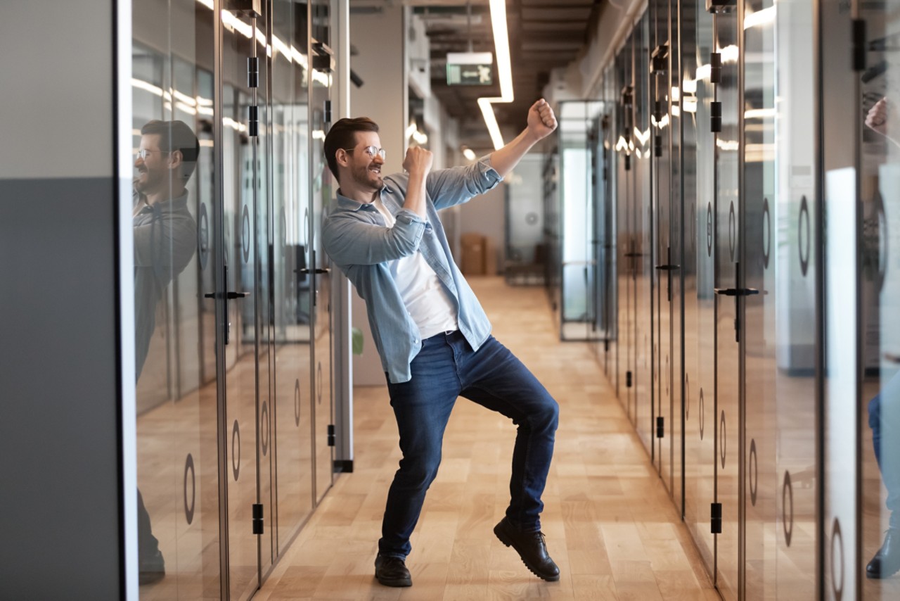 Ofis koridorunda dans eden, mutlu çalışan